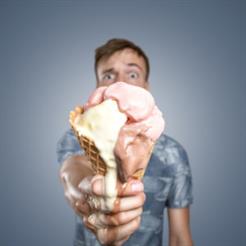 Man with a melting ice cream cone in his hand