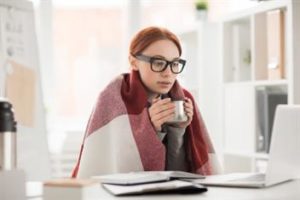 Girl having coffee while working on laptop