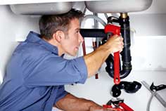 Mechanic checking garbage disposal pipe