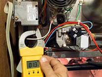 Mechanic checking furnace temperature