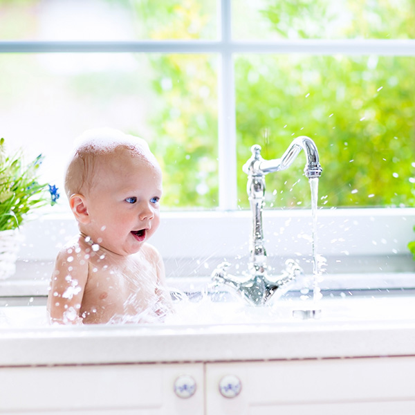 baby in sink taking bath