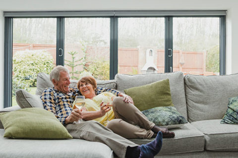 older couple cuddles on their living room couch