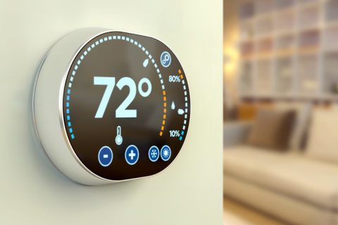 Intelligent home automation system: controlling house temperature with a multimedia touch screen display, mounted on an apartment wall and wireless connected to a main computer unit. Intelligent system for energy saving, climate control and environmental conservation. Temperature is expressed in Fahrenheit degrees (see more images from my portfolio for other units). Shows thermometer, warm and cold air conditioning icons, relative humidity and current temperature.