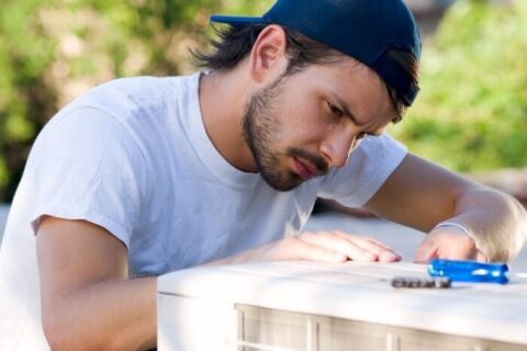 Technician Working on Heat Pump