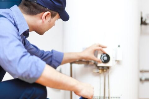 Technician installing water heater at home