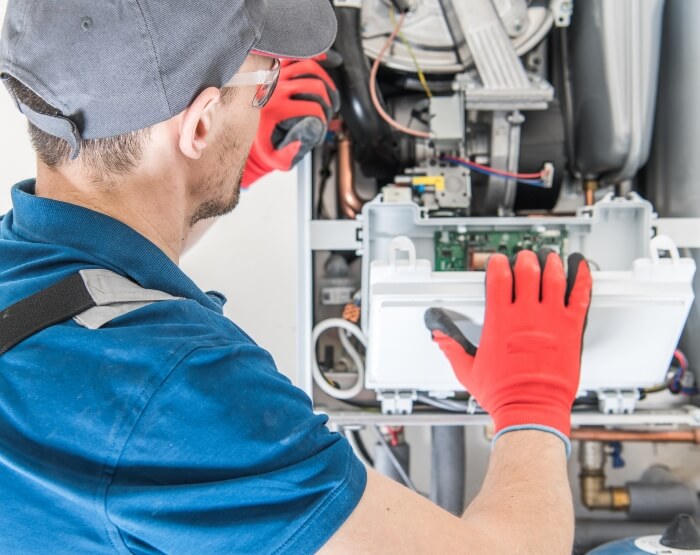 Technician Installing Furnace - Triple-T