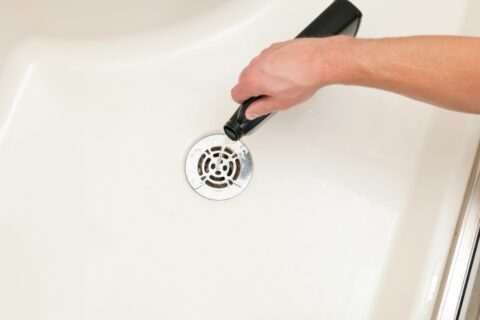 Man Cleaning Out a Clogged Shower Drain