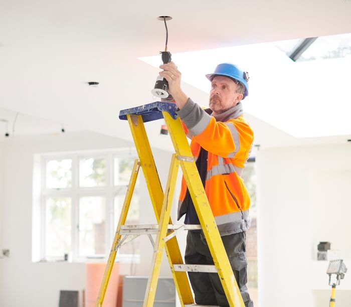 Electrician installing lights