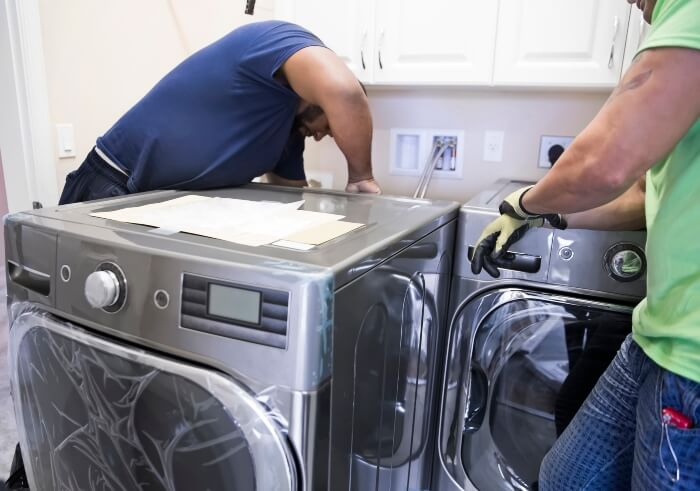 Man working on electricals and installing new Washing machine