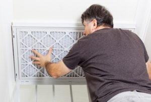 Man Replacing Air Filter - Triple-T