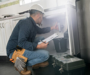 Plumber checking the pipes for descalling - Triple-T