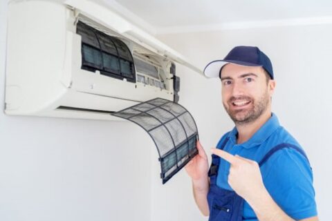 HVAC technician showing AC filter - Triple-T
