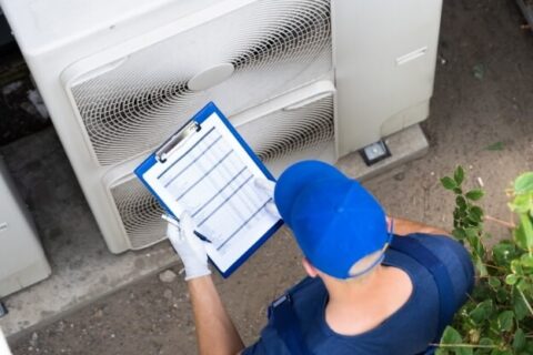 HVAC technician checking his inspection checklist