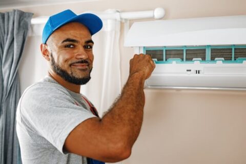 HVAC Technician Repairing ductless AC unit for a house in Utah