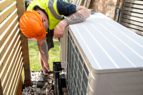 Technician checking the Heat Pump in Utah - Triple - T