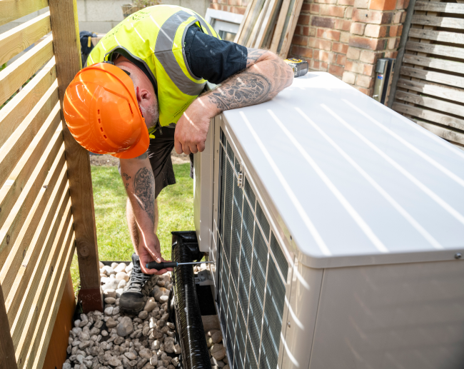 Technician checking the Heat Pump in Utah - Triple - T
