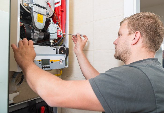 Technician repairing and resetting Gas Furnace in Utah