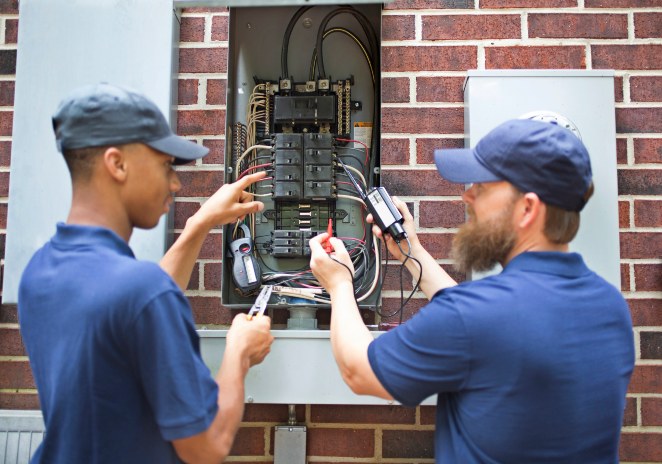 electricians working on home circuit breaker box in Utah