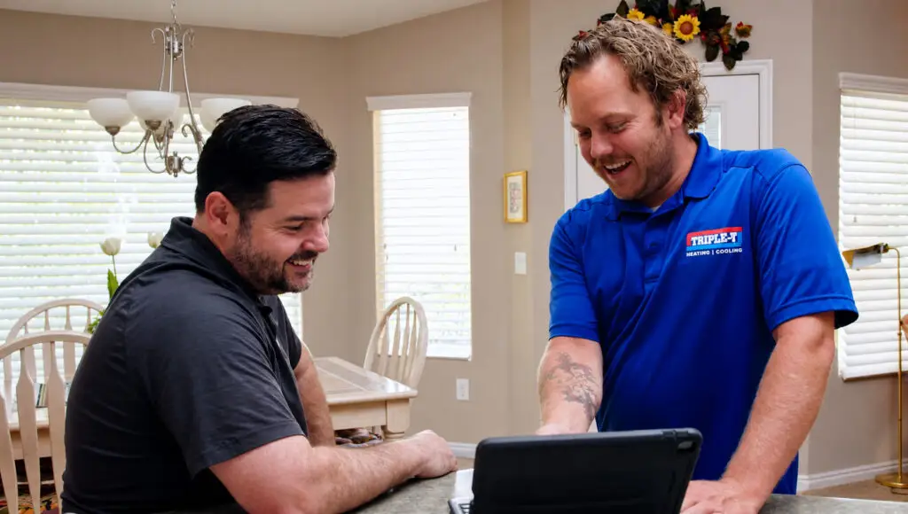 Two gentleman looking at a laptop